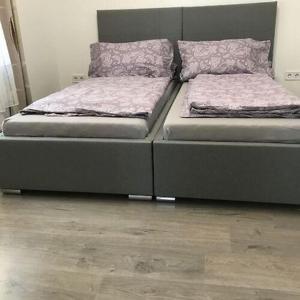 two beds sitting next to each other in a room at Villa Alex in Siófok