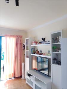 a living room with a fish tank and shelves at Casa Anita in Costa de Antigua +61 photos