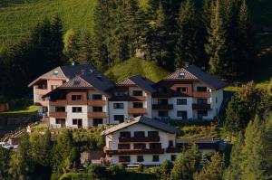 a group of houses on the side of a hill at Apartments Boè in Santa Cristina in Val Gardena