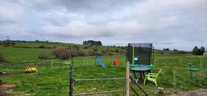 a playground in the middle of a field at Peacock Farm Estate Self Contained Lodges in Cork