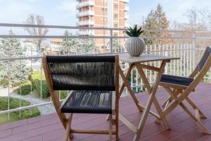 een tafel met 2 stoelen en een vaas op een balkon bij Casa Martina in Castelletto sopra Ticino