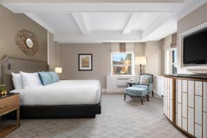 a hotel room with a bed and a tv at Fairmont Le Chateau Frontenac in Quebec City