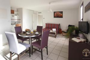 a kitchen and dining room with a table and chairs at Adonis Carcassonne in Carcassonne