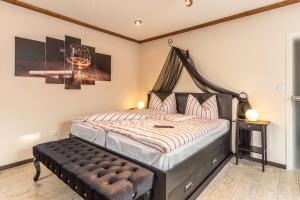 a bedroom with a large bed with a wooden headboard at Ferienwohnung Könitz, Ricarda in Naumburg +13 photos