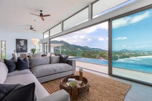 a living room with a view of the ocean at Villa Anushka - Modern luxury villa with picture-perfect sea views in Koh Samui 