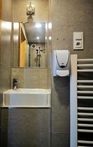 a bathroom with a sink and a mirror at Hostel 55 - darmowy parking in Wrocław