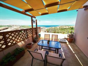 patio con mesa y sillas en el balcón en Villa Rosemari, Anatoli Apartment en Afráta