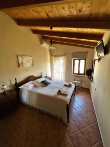 a bedroom with a large bed in a house at Villa Rosemari, Anatoli Apartment in Afráta