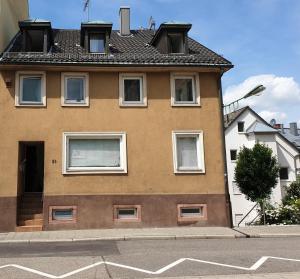 a brown building with windows on a street at Kamus in Baden-Baden