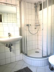 a bathroom with a shower and a sink at Kamus in Baden-Baden