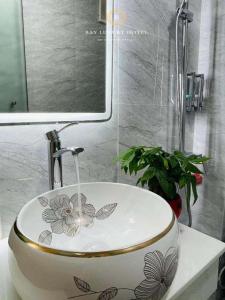 a bathroom sink with a flower design on it at A&EM VILLA HN - by BAY LUXURY in Hanoi