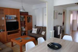 a living room with a table and a couch at Apartamento “Las Calmas” en Huesca in Huesca