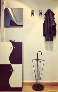 a room with a guitar and an umbrella on a wall at Apartamento “Las Calmas” en Huesca in Huesca