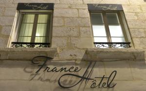 two windows on the side of a building with the words france aid at France Hôtel in Niort +60 photos