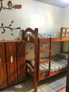 a bunk bed with a desk and a bunk bed with a shelf at Hostel Terra Viva in Pipa