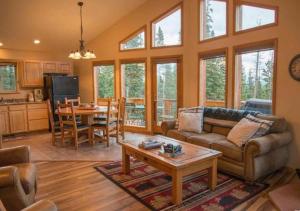 a living room with a couch and a table at NEW HOT TUB! Secluded, tucked away cabin in Fairplay