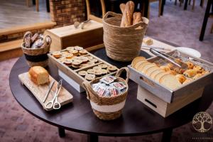 a table topped with baskets of bread and pastries at Adonis Gapotel in Gap