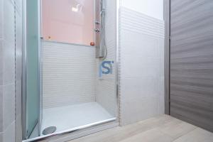 a shower with a glass door in a bathroom at B&B Panorama - Self Check in in Cefalù