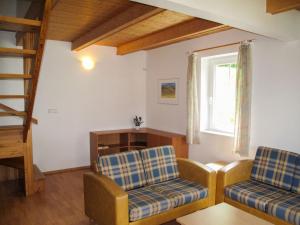 a living room with two chairs and a window at Holiday Home Holiday Hill by Interhome in Černý Dŭl