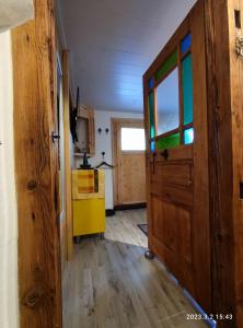 an open door to a kitchen with a yellow cabinet at Ferienwohnung Schug in Homburg