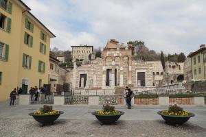 a group of people standing in front of a building at Pallata 52 in Brescia