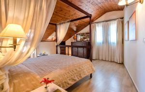 a bedroom with a bed and a wooden ceiling at Spilia Village Hotel & Villas in Spiliá
