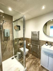 a bathroom with a shower and a toilet and a sink at Tolcarne - Perranporth Cornwall in Perranporth +85 photos