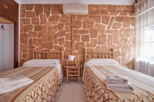 Postel nebo postele na pokoji v ubytování Hotel Virgen de los Reyes