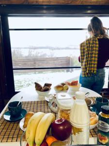 a woman standing in front of a table full of food at Glamping&BeerSpa Scialla Sul Lago in Pignola +42 photos