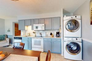 a kitchen with blue cabinets and washing machines in it at Fall Creek Resort Pond View Escape in Branson