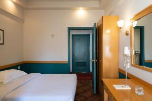 A bed or beds in a room at Hotel Ntinas