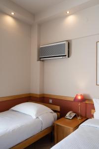 A bed or beds in a room at Hotel Ntinas
