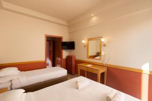 A bed or beds in a room at Hotel Ntinas