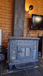 a fireplace with a tv on top of it at Chalet Coo in Stavelot