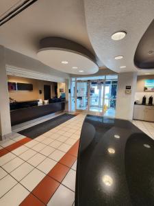 a lobby with a black chair in a building at Motel 6-Biloxi, MS - Beach in Biloxi