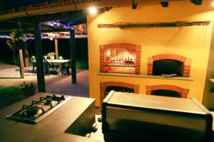 a kitchen with a stove and a fireplace at Villa Ariola in Villafranca in Lunigiana