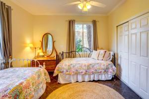 a bedroom with two beds and a mirror and a window at Fallbrook Vacation Rental 3 Mi to Wineries! in Fallbrook