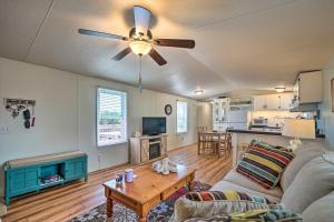a living room with a couch and a ceiling fan at Peaceful Supply House about 2 Mi to Holden Beach! in Supply +19 photos