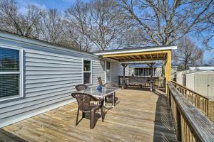 a patio with a table and chairs on a deck at Peaceful Supply House about 2 Mi to Holden Beach! in Supply