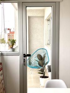 a blue chair sitting on a balcony next to a window at Dpto luminoso excelente zona in La Plata