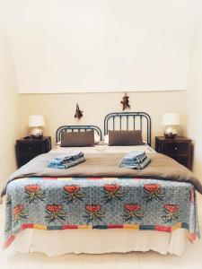 a bedroom with a large bed with a blanket on it at Masseria I Raffi b&b in Monopoli