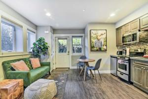 a living room with a green couch and a table at Walkable Portland Studio Less Than 1 Mi to Dtwn! in Portland