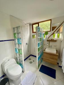 a bathroom with a toilet and a sink at Casa Magnolia in Cumbayá