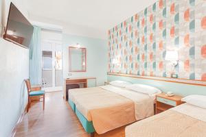 Ein Bett oder Betten in einem Zimmer der Unterkunft Hotel Fantini