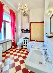 a bathroom with a large sink and a checkered floor at Wägner´s Heim in Dresden
