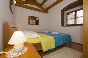 a bedroom with a bed and a table with a lamp at Mon Perin Castrum - Apartment Ivan in Bale