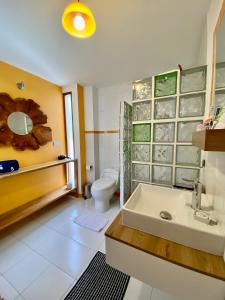 a bathroom with a sink and a toilet at Casa Magnolia in Cumbayá