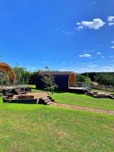 a building in a field with a grass field at Finest Retreats - Hundle Dale in York