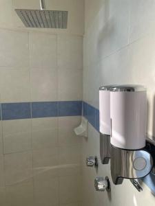 a bathroom with a toilet paper dispenser on the wall at Casa Málaga in Zamora de Hidalgo