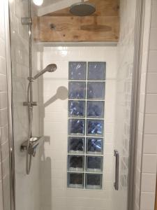 a shower with a glass window in a bathroom at Là-Haut "Maison d'hôtes" in Antraigues +39 photos